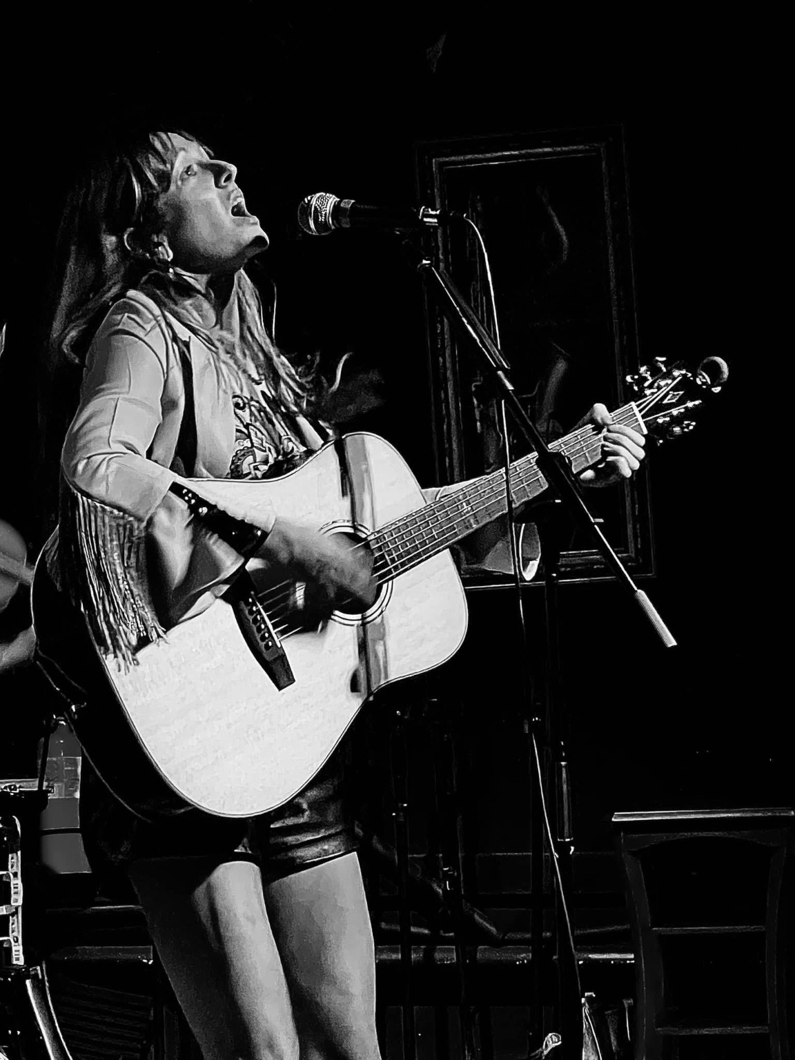 Tiffany Huber performing with an acoustic guitar